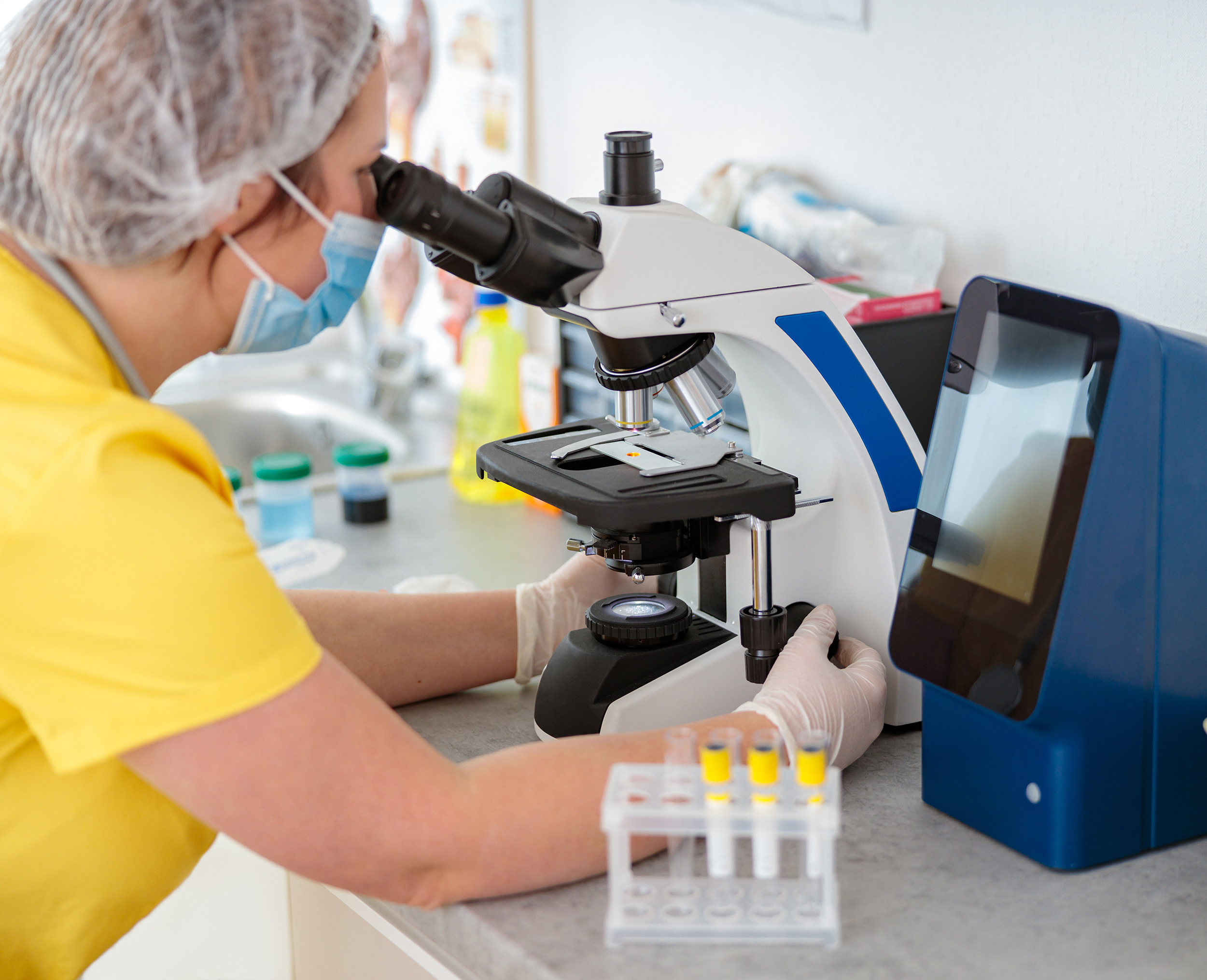 Person looking into microscope